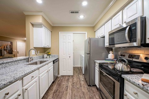 a kitchen with stainless steel appliances and granite counter tops