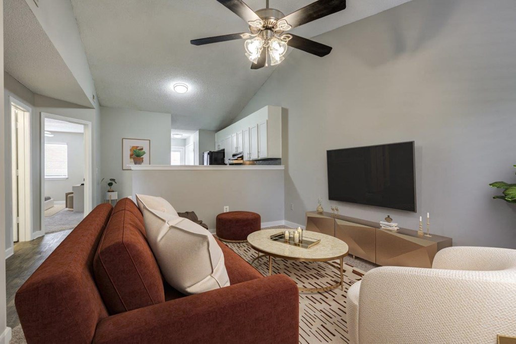 a living room with a couch and a ceiling fan
