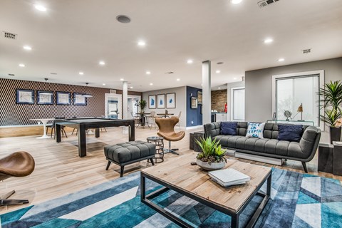 A modern living room with a wooden coffee table and a grey sofa.