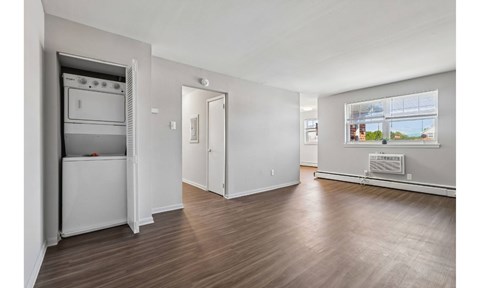 A white kitchen with a refrigerator, oven, and microwave.