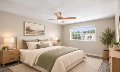 A bedroom with a bed, nightstands, and a ceiling fan.