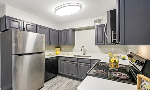 A kitchen with a stove top oven and a refrigerator.