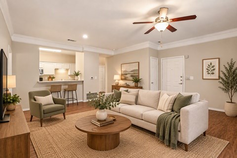 A living room with a white couch, a coffee table, and a ceiling fan.
