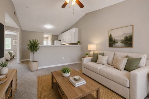 A living room with a couch, coffee table, and a painting on the wall.