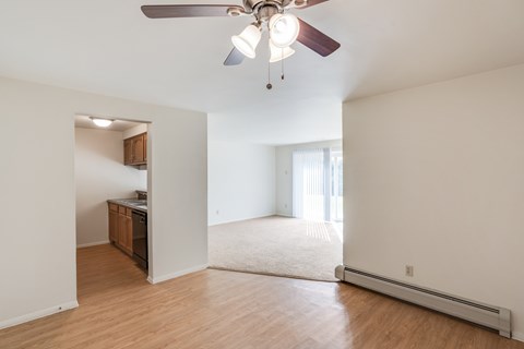 Dining room with hardwood floor and ceiling fan.