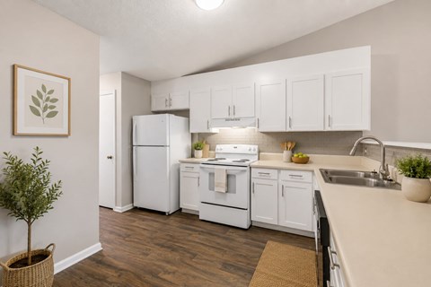 A kitchen with white appliances and cabinets.