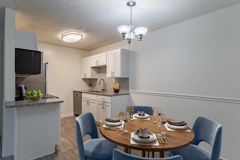A kitchen with a dining table set for four.