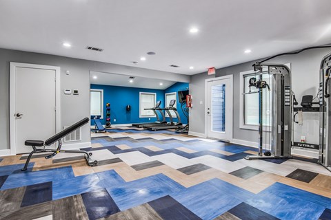 A gym with a blue and brown checkered floor.
