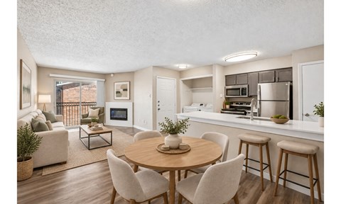 A well-lit kitchen with a dining table and chairs.