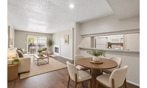 A dining room with a round table and chairs.
