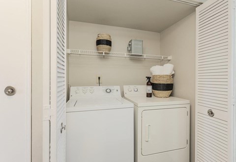 A small laundry room with a washer and dryer.