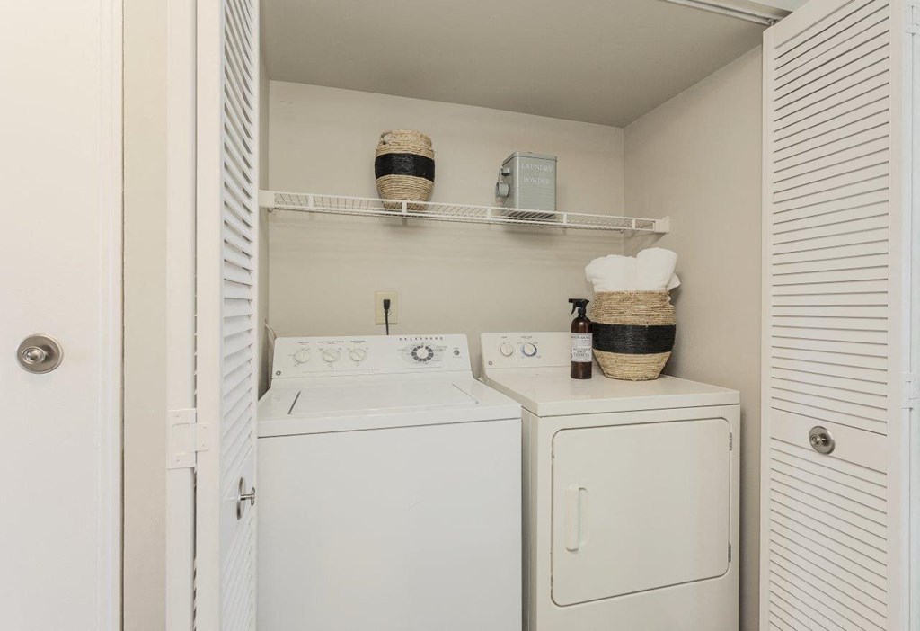 A small laundry room with a washer and dryer.