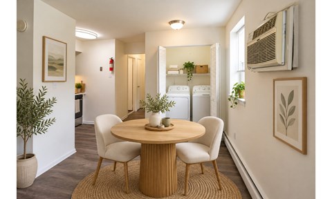 A dining room with a round table and chairs.