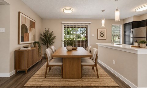 A dining room with a wooden table and chairs.