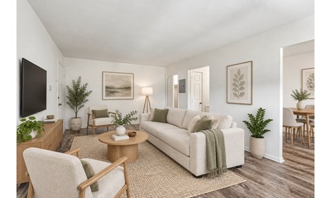 A living room with a couch, chairs, and a coffee table.