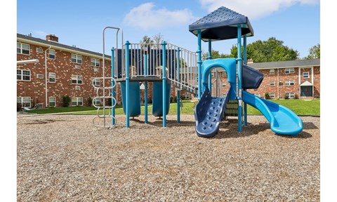 A blue playground structure with a slide and a tower.