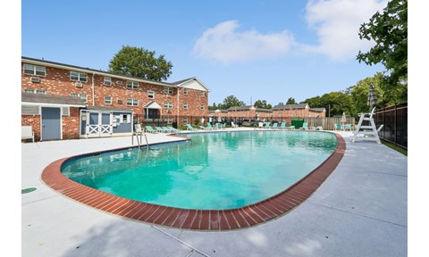 A small pool with a red brick border.