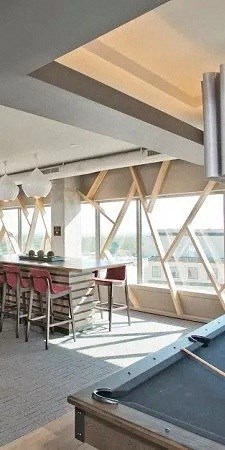 a large room with a pool table and chairs