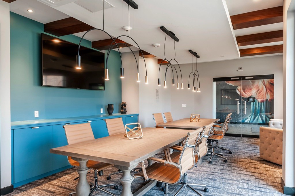 A conference room with a long table and chairs.