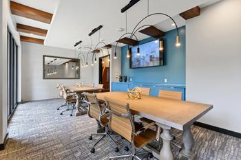 A conference room with a long table and chairs.