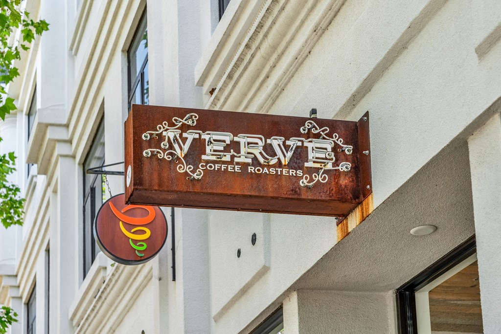 a sign for a coffee shop on the side of a building