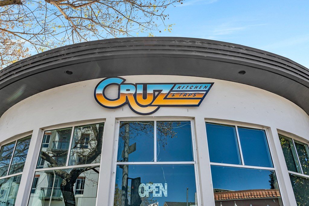 a building with a cuyo open sign on top of it