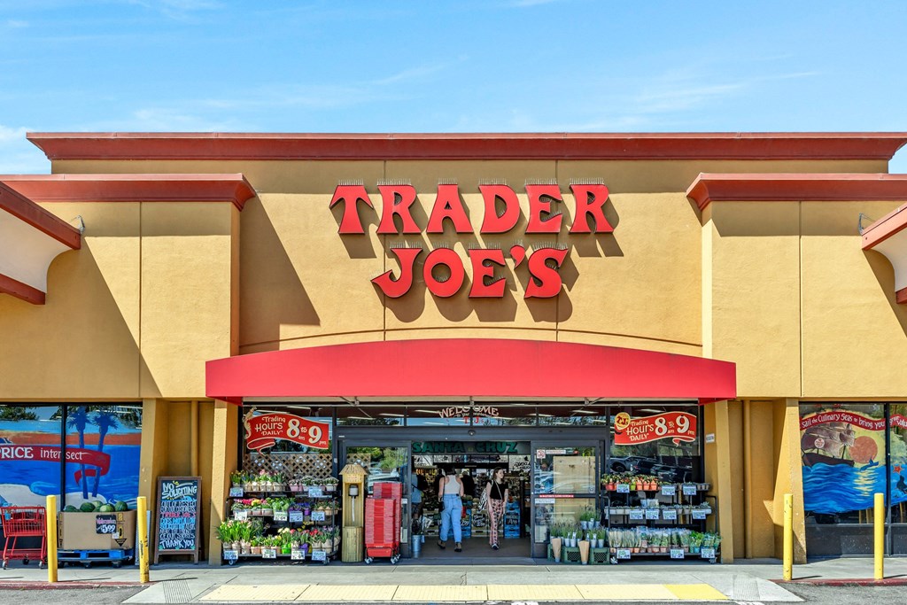a trader joes store with a red sign on the front of it