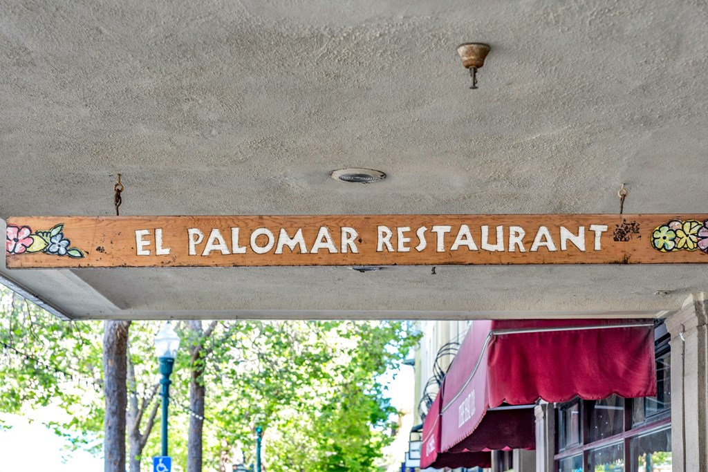the sign for the el palomar restaurant on the front of a building