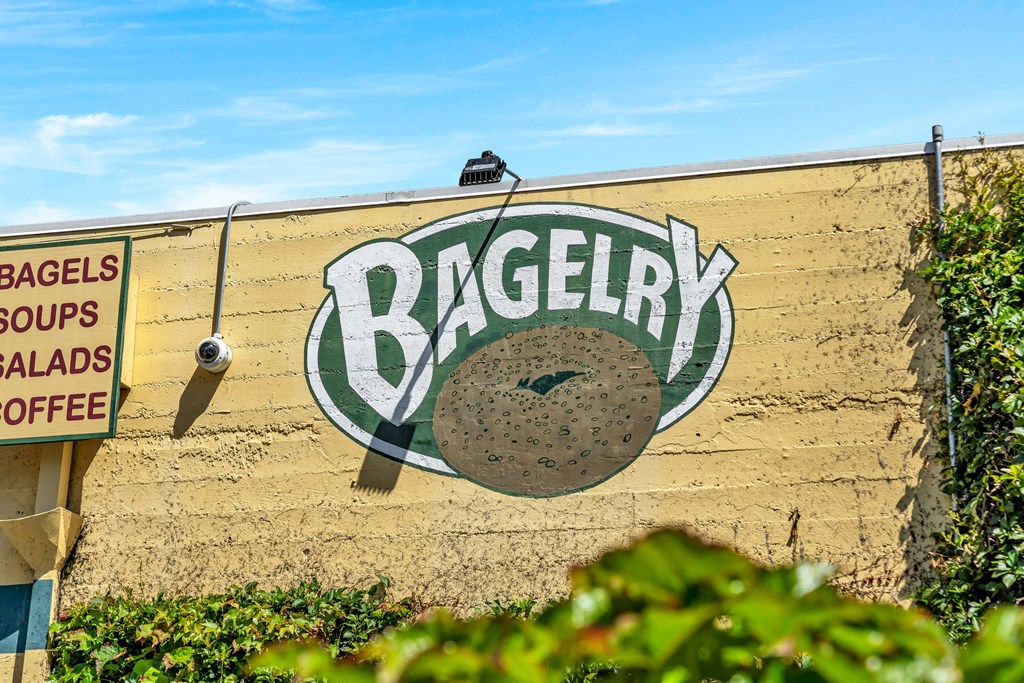 a sign for a bagel on the side of a wall