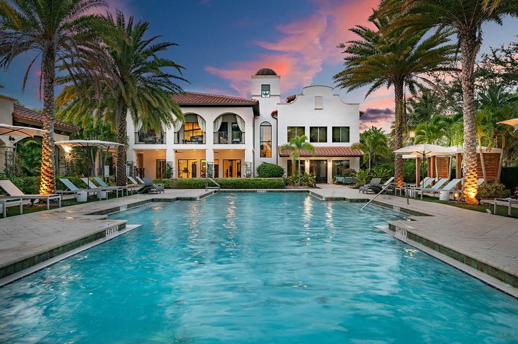A large house with a pool in front of it.