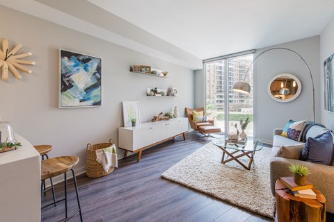 A living room with a white sofa and a wooden coffee table.