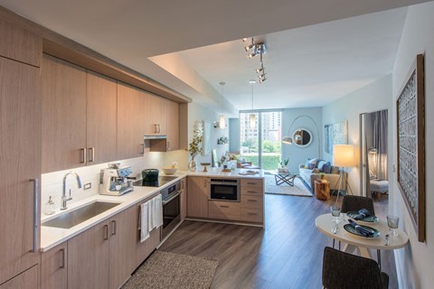 A modern kitchen with wooden cabinets and a large island.