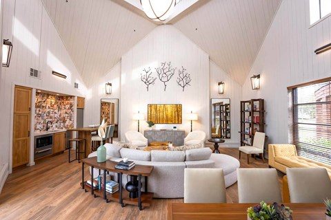 A living room with a white couch and a wooden coffee table.