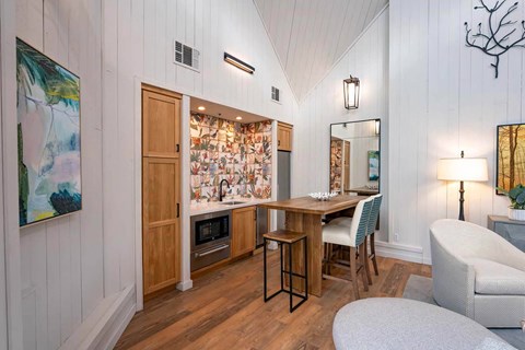 A kitchen with a table and chairs in front of a mural.