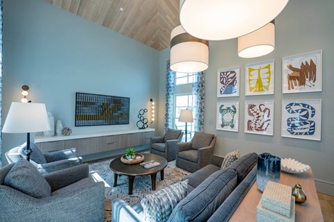 A living room with a grey couch and a wooden table.