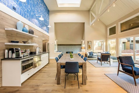 A modern kitchen with a dining table set for six.