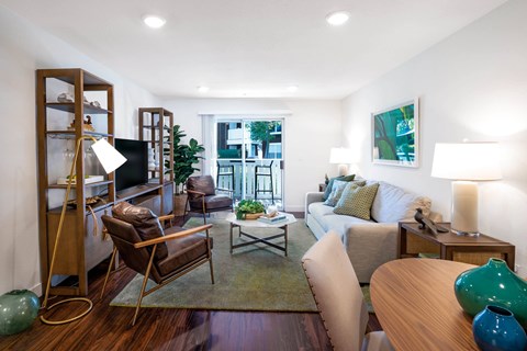A living room with a brown chair and a white couch.
