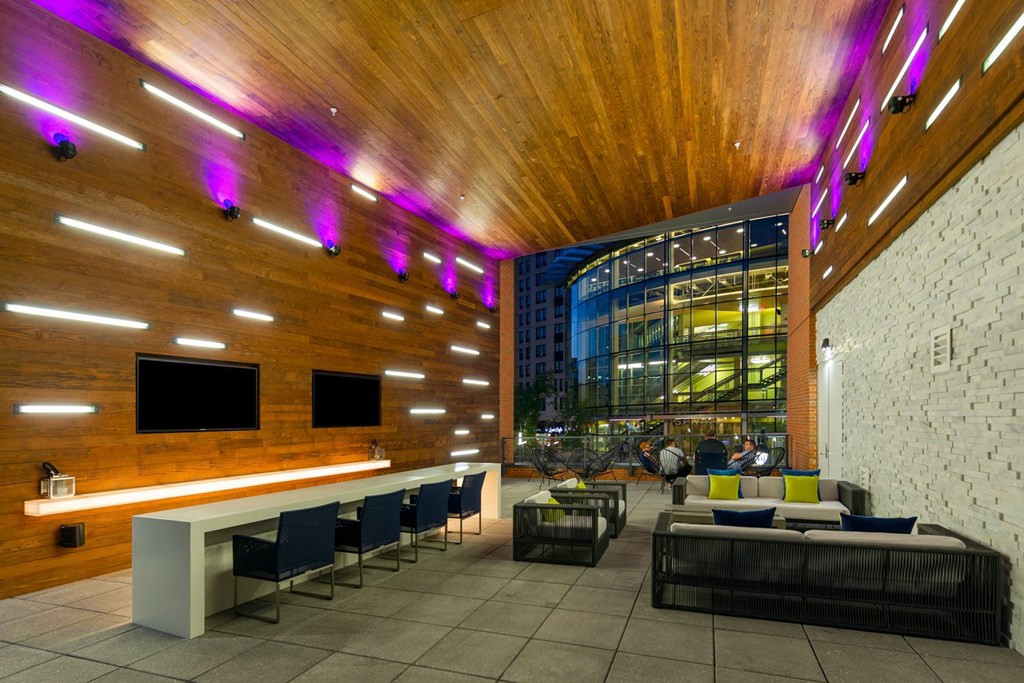 A modern room with a long white table and chairs.