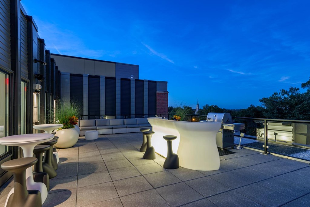 A modern outdoor seating area with a white table and chairs.