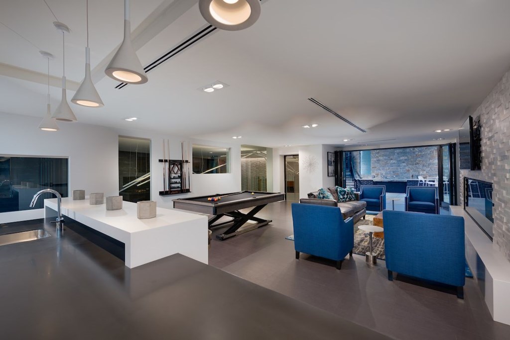 A modern kitchen with a dining area and a living room.
