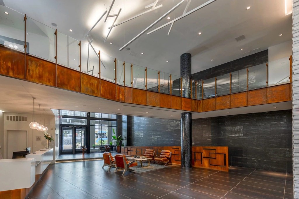 A modern interior with a black floor and a white reception desk.