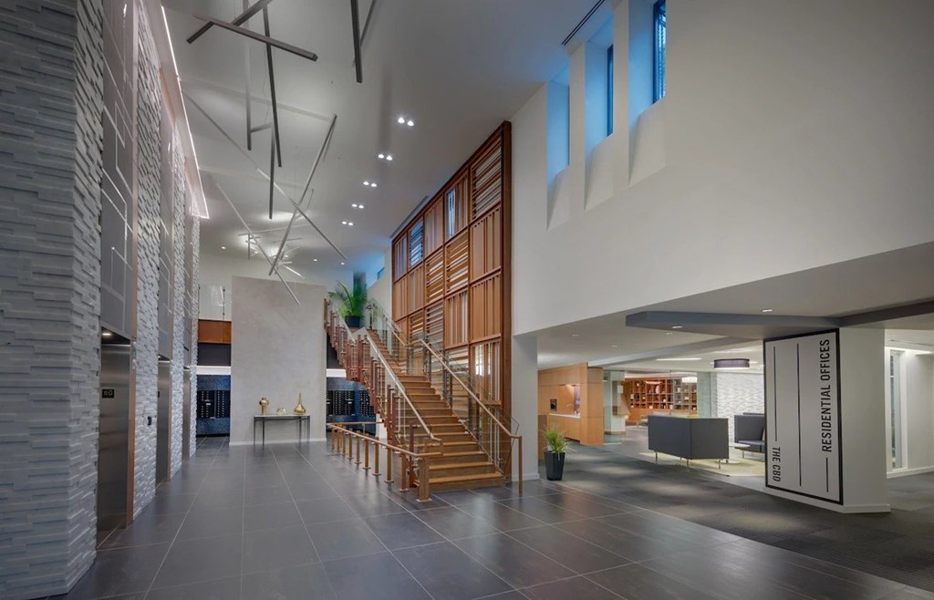 A modern interior space with a staircase and a glass wall.