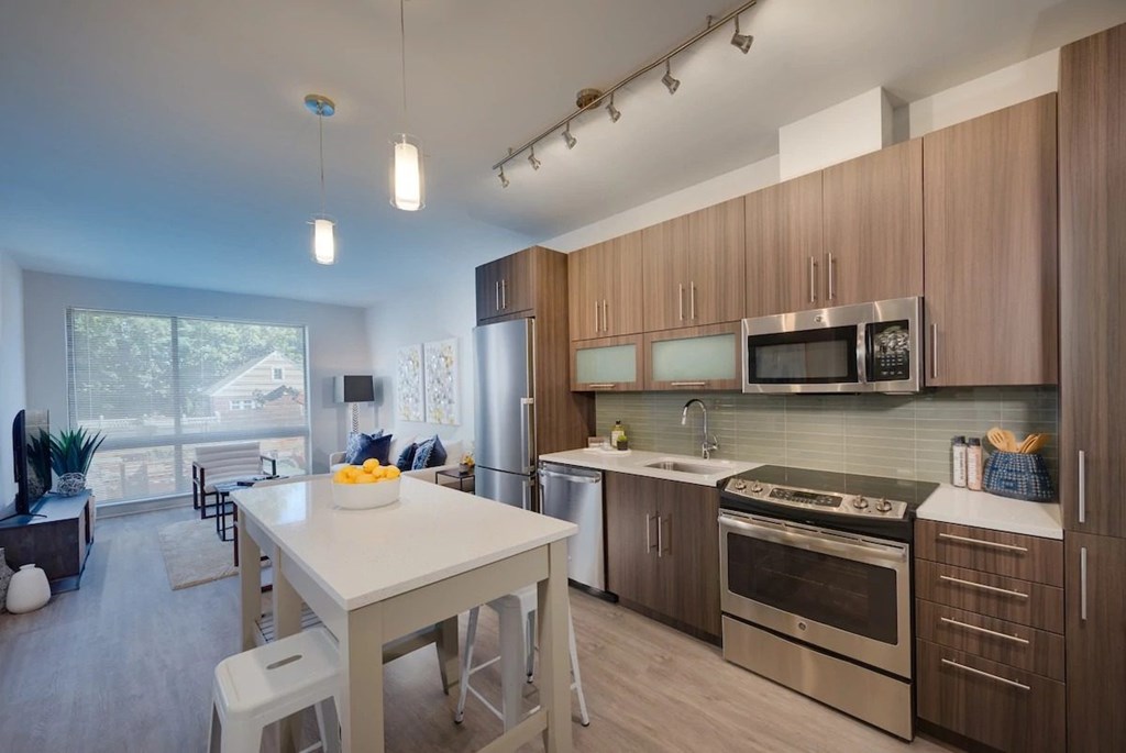 A modern kitchen with a dining table and chairs.
