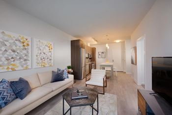 A living room with a white couch and a coffee table.