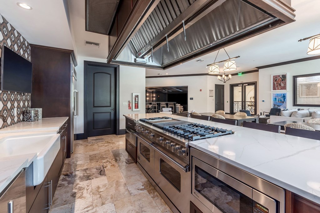 A modern kitchen with a large island and stainless steel appliances.