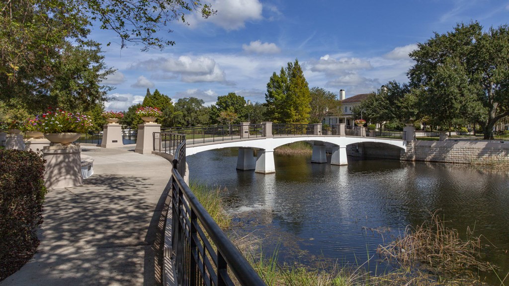 A bridge over a river with a walkway on the left side.