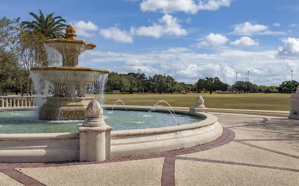 A large fountain in the middle of a park.