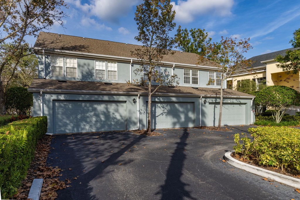 A house with a grey garage door and a driveway.