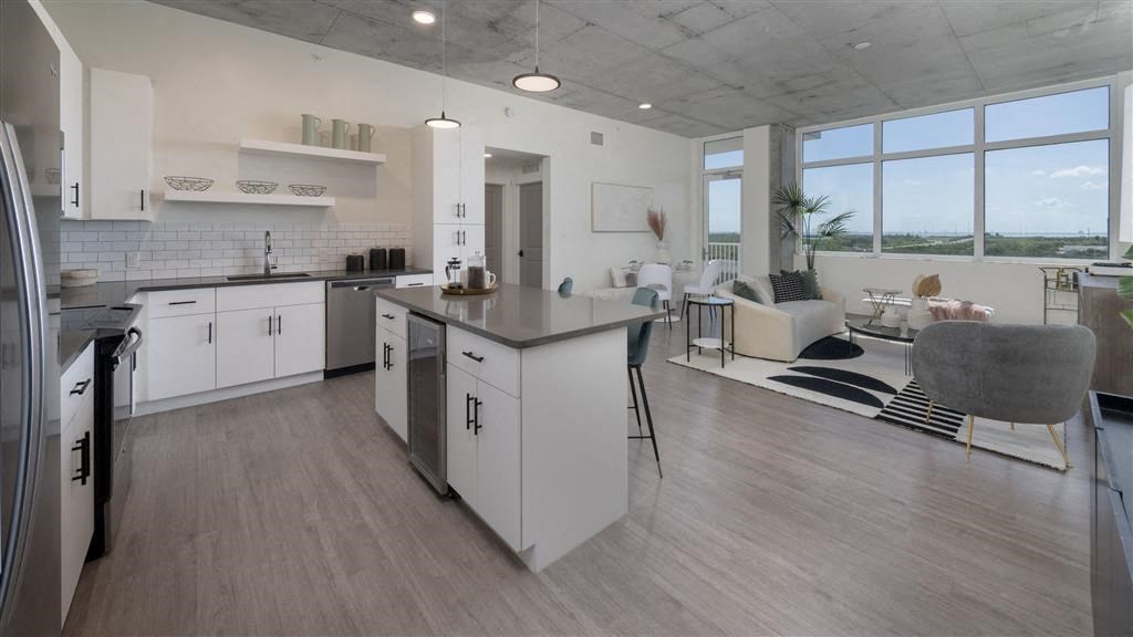 A modern kitchen with white cabinets and a large island.