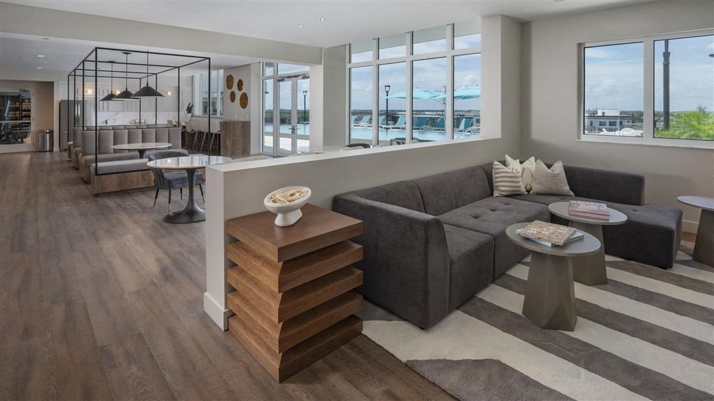 A modern living room with a grey sofa and a wooden side table.